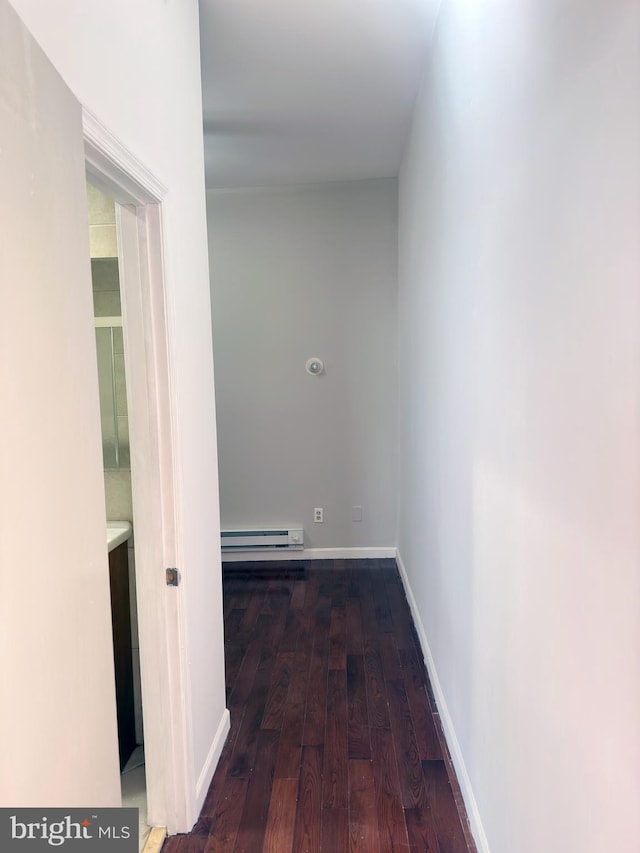 corridor featuring dark hardwood / wood-style flooring and baseboard heating