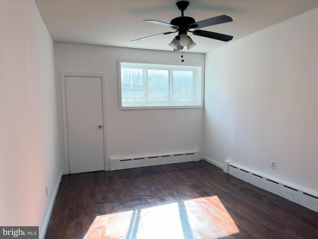 unfurnished room with ceiling fan, baseboard heating, and dark wood-type flooring