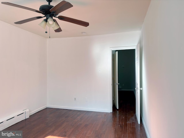 empty room featuring ceiling fan, a baseboard heating unit, and dark hardwood / wood-style flooring