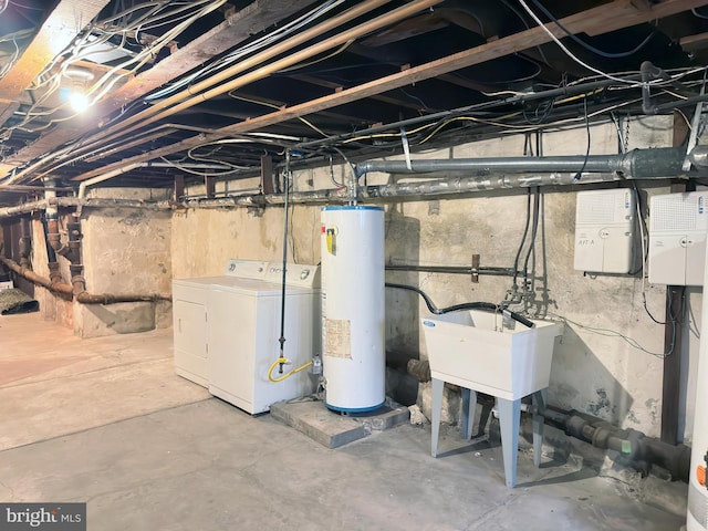 basement with sink, water heater, and washing machine and clothes dryer