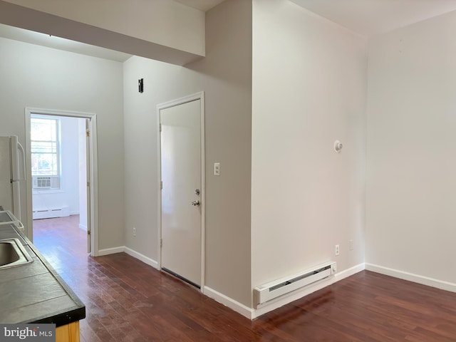 hallway featuring sink, dark hardwood / wood-style floors, and a baseboard heating unit