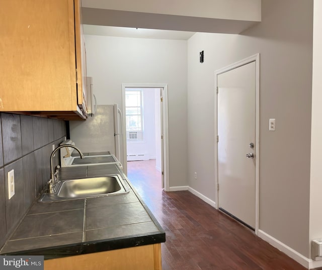 kitchen featuring sink, dark wood-type flooring, and baseboard heating