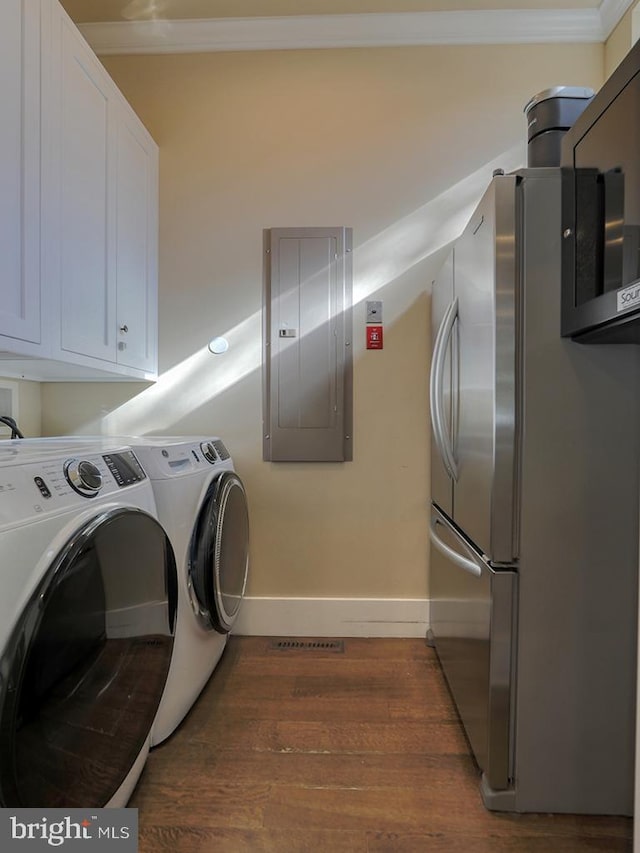 laundry room with washer and clothes dryer, crown molding, dark wood-type flooring, hookup for a washing machine, and cabinets