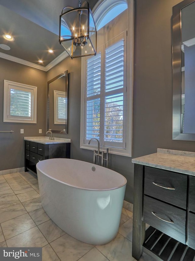 bathroom with tile flooring, oversized vanity, crown molding, and plenty of natural light