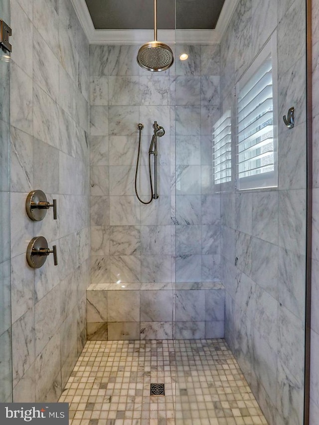 bathroom featuring crown molding and tiled shower