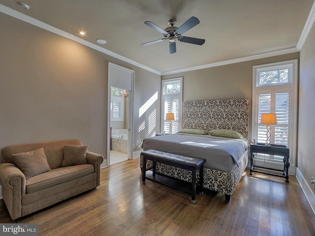 bedroom with ensuite bath, dark hardwood / wood-style flooring, crown molding, and multiple windows