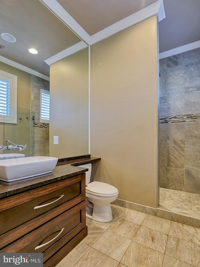 bathroom featuring ornamental molding, toilet, tile floors, and vanity