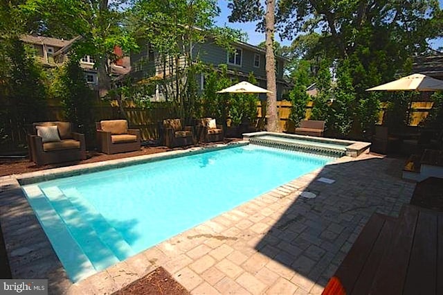 view of swimming pool with a patio area and an in ground hot tub