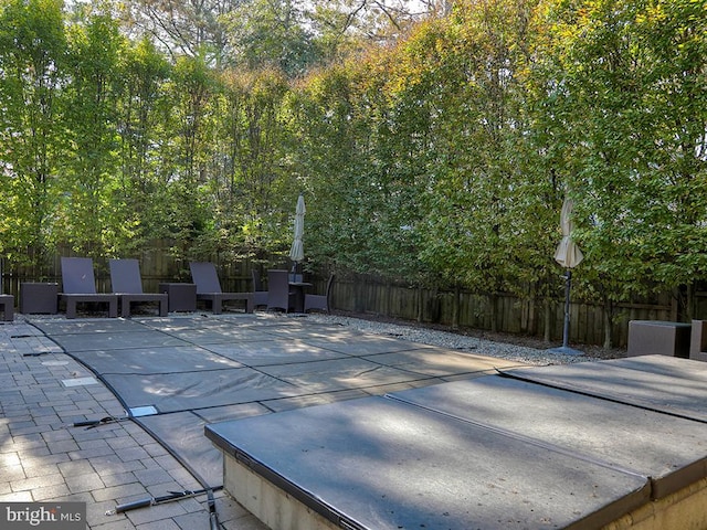 view of patio / terrace with a covered pool