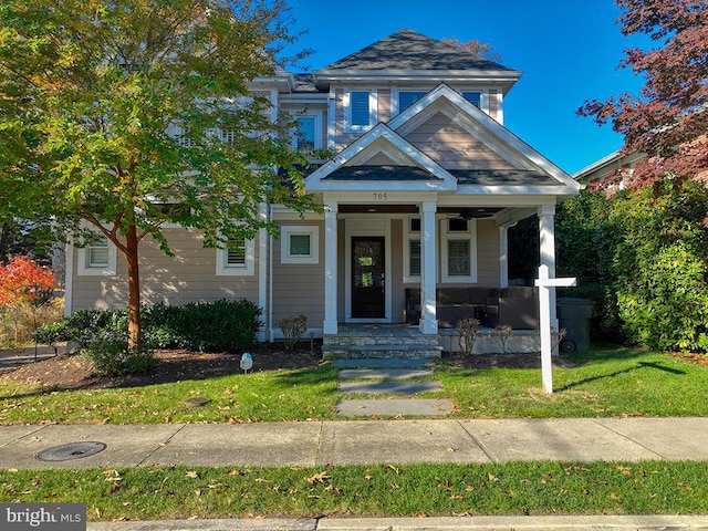 view of front facade with a front yard and a porch