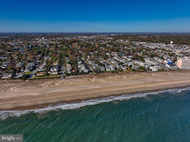 bird's eye view featuring a water view and a view of the beach