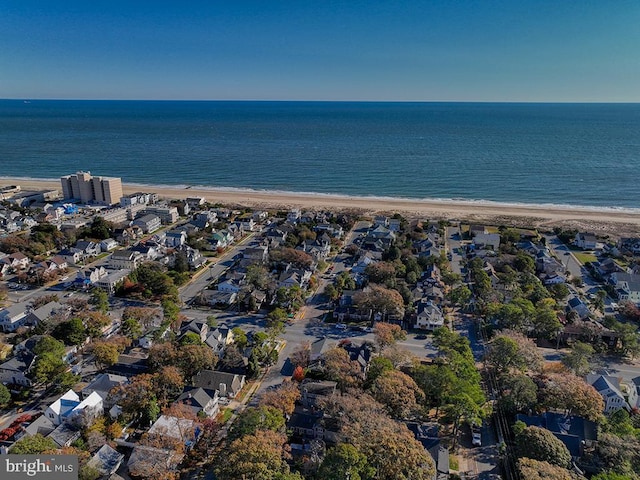 birds eye view of property with a view of the beach and a water view