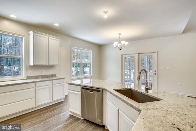 kitchen with decorative light fixtures, sink, white cabinets, a chandelier, and stainless steel dishwasher