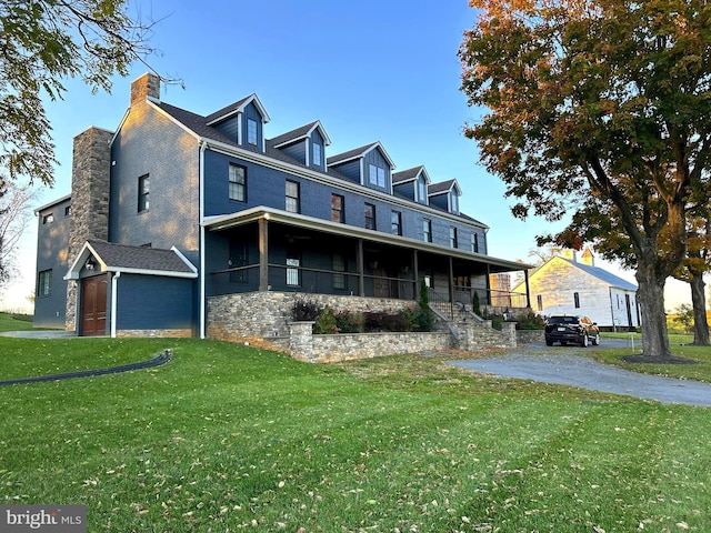 exterior space featuring a front lawn and covered porch