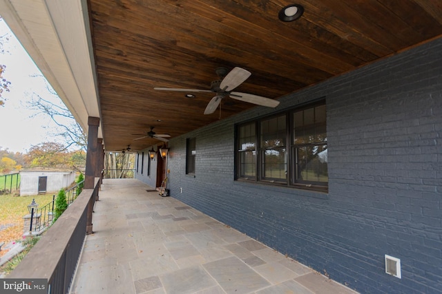 view of patio / terrace with a shed and ceiling fan