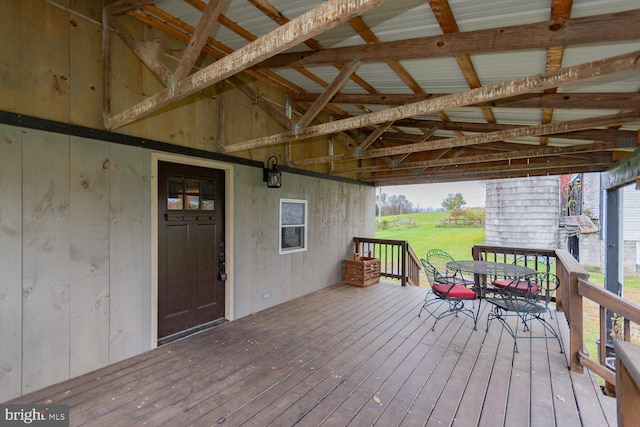 wooden terrace featuring a lawn