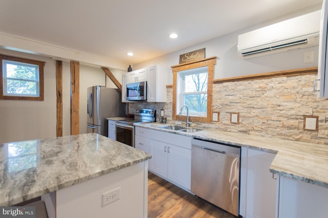 kitchen with white cabinets, a healthy amount of sunlight, sink, and appliances with stainless steel finishes