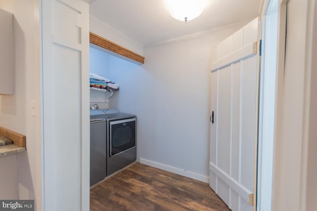clothes washing area featuring washer and dryer and dark wood-type flooring