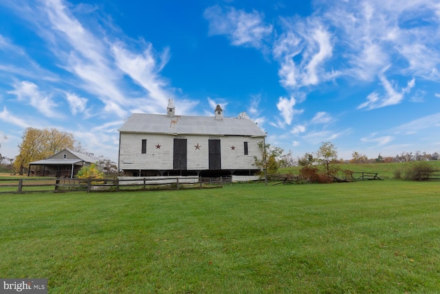 rear view of house featuring a lawn