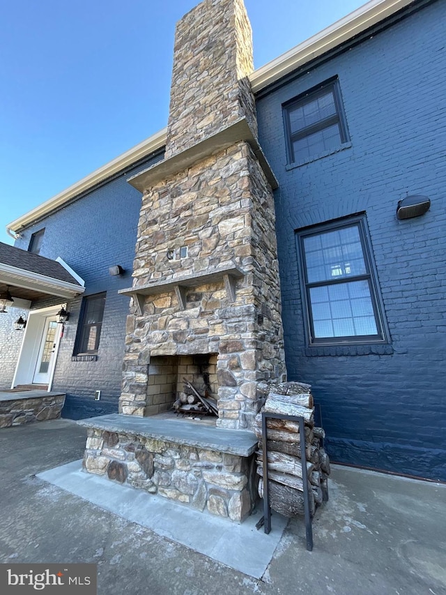 view of patio with an outdoor stone fireplace