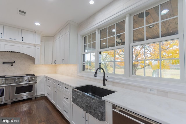kitchen with white cabinets, dark hardwood / wood-style floors, sink, and appliances with stainless steel finishes