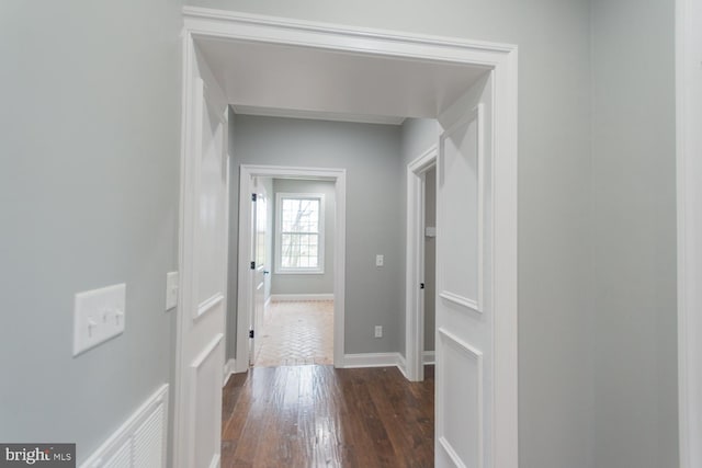 hallway with dark hardwood / wood-style floors
