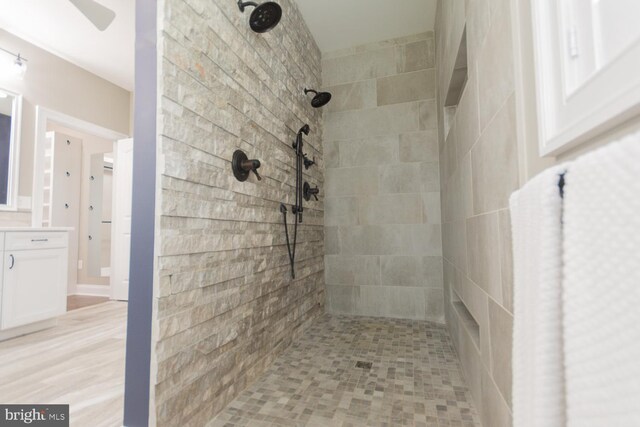 bathroom featuring a tile shower and hardwood / wood-style flooring