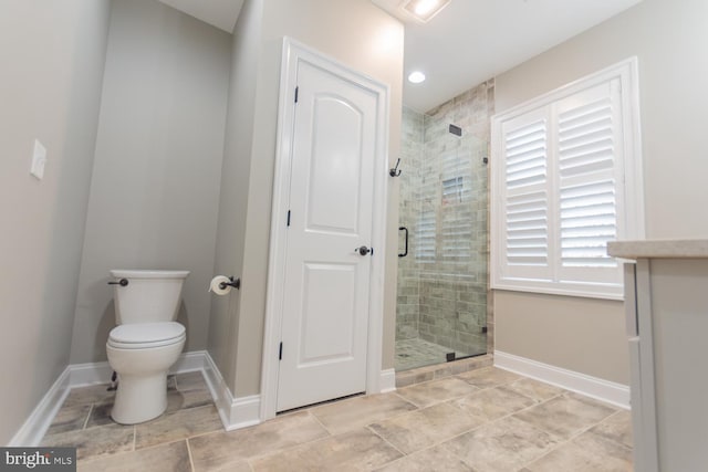 bathroom featuring toilet and walk in shower