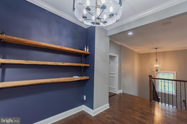interior space with dark hardwood / wood-style flooring, an inviting chandelier, and ornamental molding