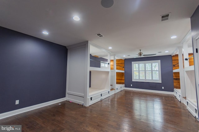 unfurnished living room featuring ceiling fan and dark hardwood / wood-style flooring