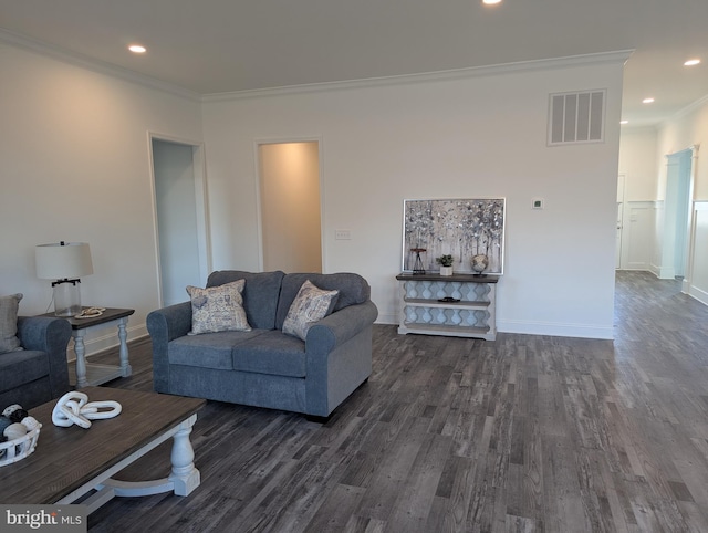 living room featuring dark hardwood / wood-style flooring and ornamental molding