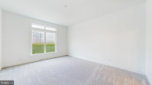 empty room featuring light colored carpet