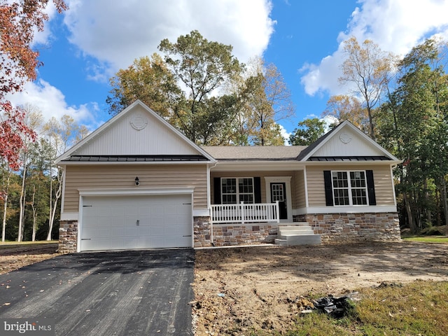 view of front of house with a porch and a garage