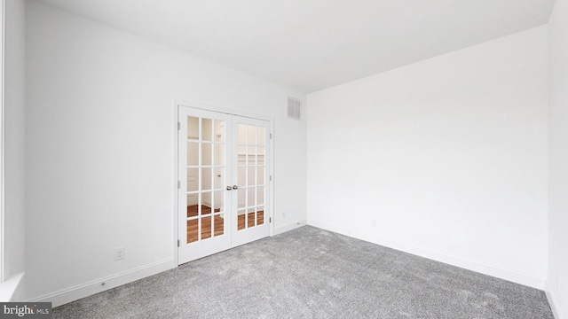 unfurnished room with carpet and french doors