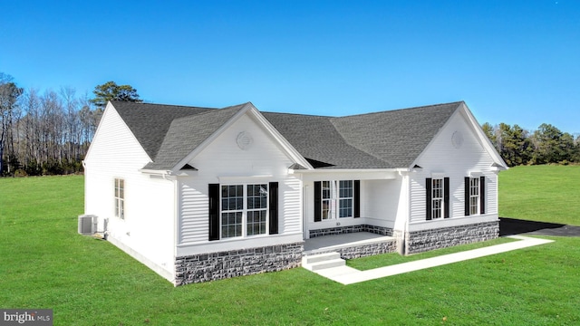 view of front of home featuring central air condition unit and a front lawn