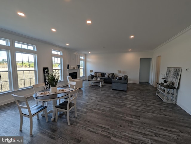 dining area with dark hardwood / wood-style floors and crown molding