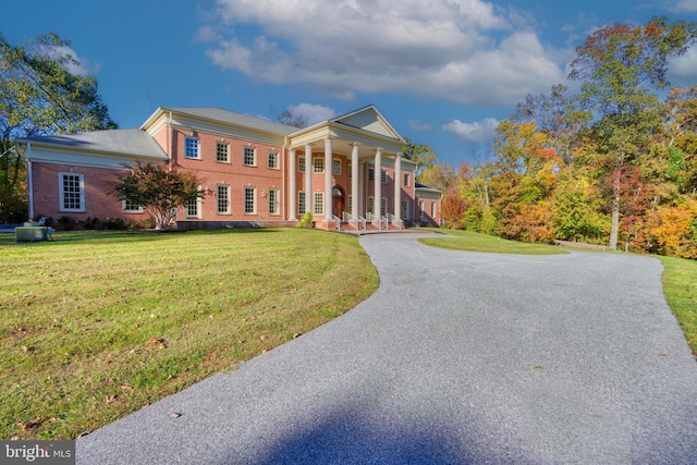 neoclassical / greek revival house featuring a front lawn