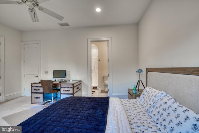 carpeted bedroom with ensuite bathroom and ceiling fan