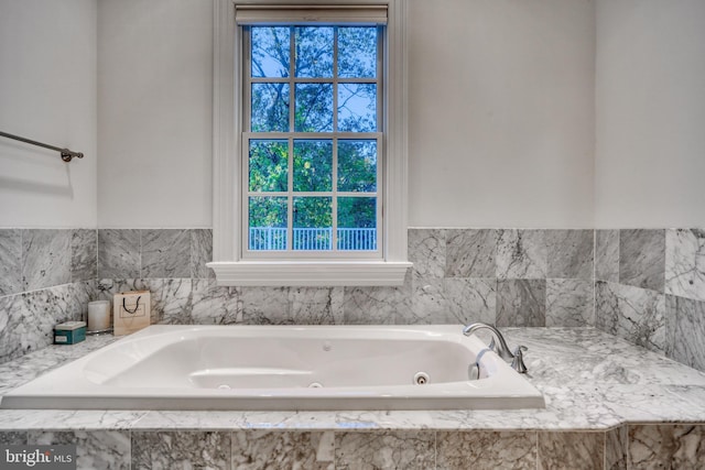 bathroom featuring a relaxing tiled bath