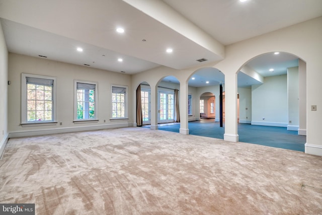 carpeted spare room featuring ornate columns