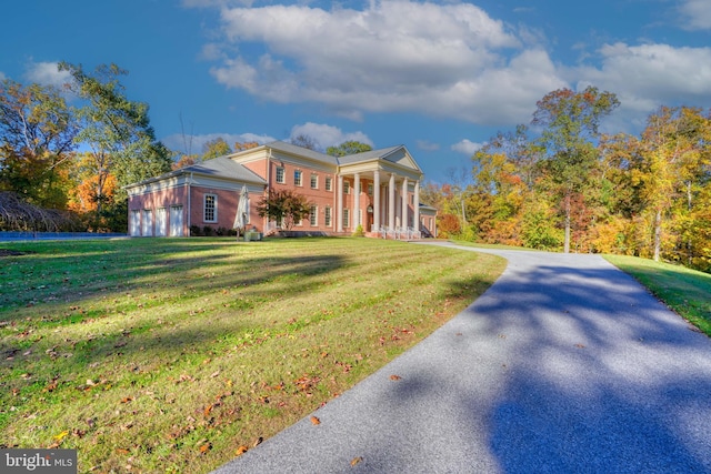 greek revival inspired property with a front lawn