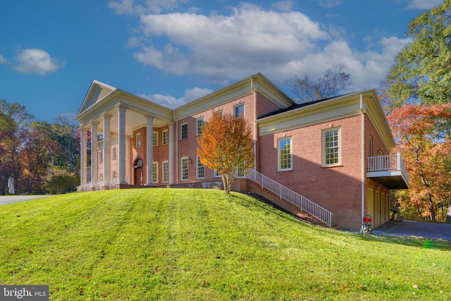 greek revival inspired property with a front yard