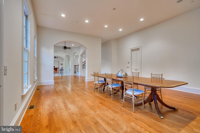 dining area with ceiling fan and light wood-type flooring