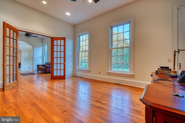 interior space featuring french doors, ceiling fan, and light wood-type flooring