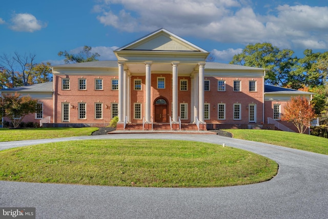 neoclassical home with a front yard