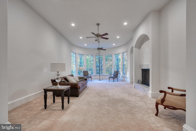 carpeted living room featuring ceiling fan