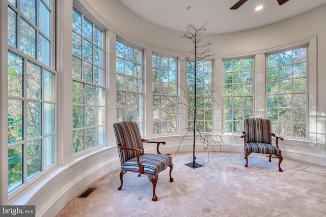 sunroom / solarium featuring ceiling fan and plenty of natural light