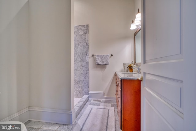 bathroom featuring a shower, toilet, tile flooring, and oversized vanity