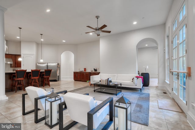 tiled living room with ceiling fan