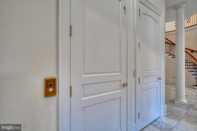 room details featuring decorative columns and light tile floors